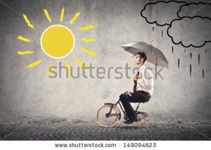 stock-photo-young-businessman-rides-a-bike-with-umbrella-149094623